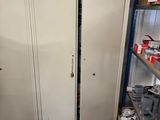 a tall white door in a room with shelves
