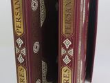 two books that are open on a white surface