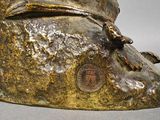 a bronze statue of a man with a hat on his head