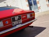 a red car that is parked in front of a building
