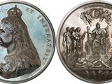 an image of a silver coin with a picture of a woman on it