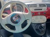 a man sitting in a car with his feet on the steering wheel