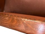 a close up of a brown leather chair with a white background