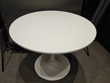 the table is white and has a circular base with a circular base
