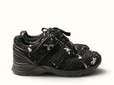 the black and white shoes are on a white surface