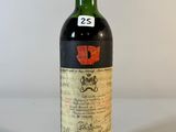une vieille bouteille de vin posée sur une table blanche