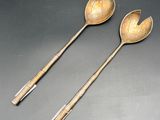 two spoons and a spoon rest on a table