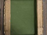 an old picture frame with a green background and a wooden frame