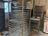 many trays of food that are on a cart in the kitchen