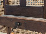 a wooden chair that has a handle on it