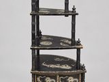 a black and white shelf with three shelves on top of it