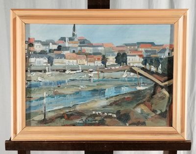 a painting on a easel with a painting of a city in the background