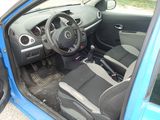 the interior of a small blue car with the door open