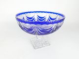 purple and blue glass bowl sitting on a clear base