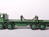 a green toy truck with a chain on the back of it