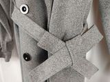 a close up of a coat hanging on a wall