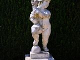 a statue of a boy holding a baby in his arms