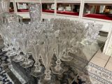a lot of wine glasses sitting on a glass table