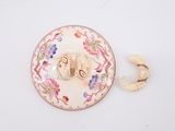 a white plate with a pink and blue design on it