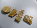 three pieces of carved soap sitting on top of a white surface