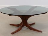 a glass table with a wooden base and a glass top