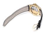 a close up of a watch on a white surface with a black strap