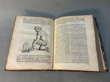 an open book with a drawing of a man kneeling on the ground