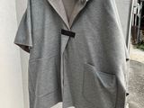 grey coat with fur collar and hood hanging on a wall