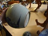 a person holding a blue and white bowl on a table