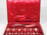 a red case with silverware in it on a white surface
