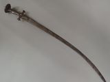 a very old sword that is laying on a table