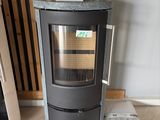 a black stove sitting in a room next to a wall