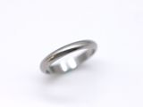 a close up of a wedding ring on a white surface