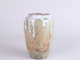 a white and brown vase sitting on a white surface