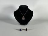 necklace and earring set on a mannequin stand