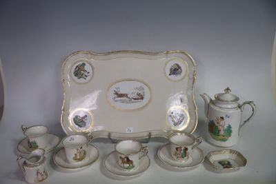 une table avec un plateau, des tasses et des soucoupes, ainsi qu'un plateau orné d'images d'animaux