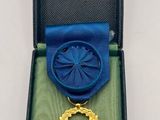 a blue and gold medal with a star on it