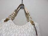 a white purse with a gold chain hanging from it ' s shoulder