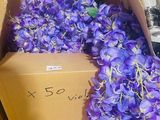 a box full of purple flowers sitting on a table