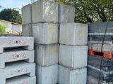 several stacks of concrete blocks stacked on top of each other in a parking lot
