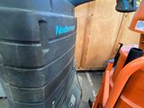 a machine that is sitting on the ground next to a chair