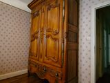 a large wooden cabinet in the corner of a room