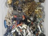 a bag full of assorted jewelry on a table