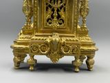 a gold clock that is sitting on a table