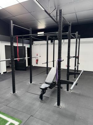 an image of a gym room with a bench and a football field