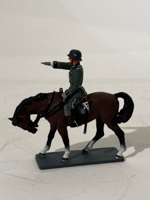 a figurine of a man on a horse with a gun