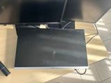 a laptop computer sitting on top of a desk next to a monitor
