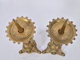 pair of antique brass candlesticks with lion heads on them