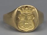 an image of a gold signet with a crown on top of it