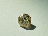 a yellow diamond that is sitting on a table